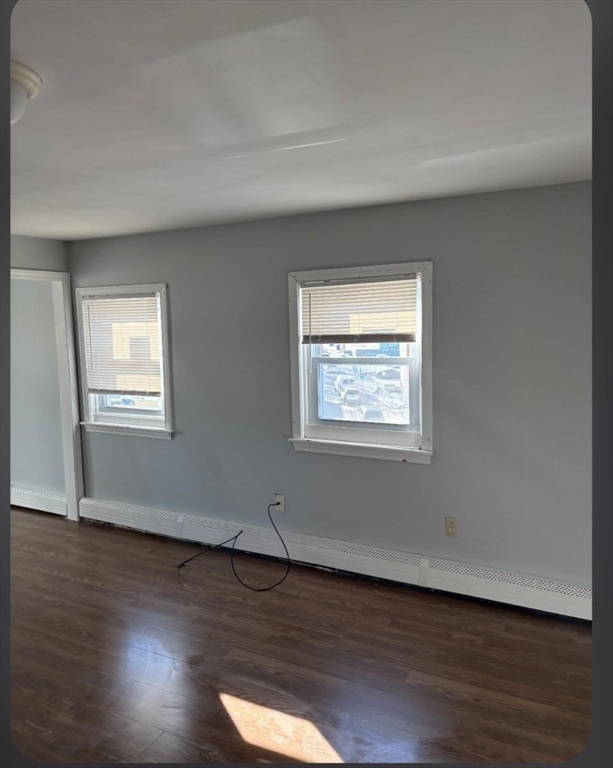 371 4th Street, Unit 3E Fall River, MA 02721 - Photo 5 of 9 an empty room with wooden floor and windows