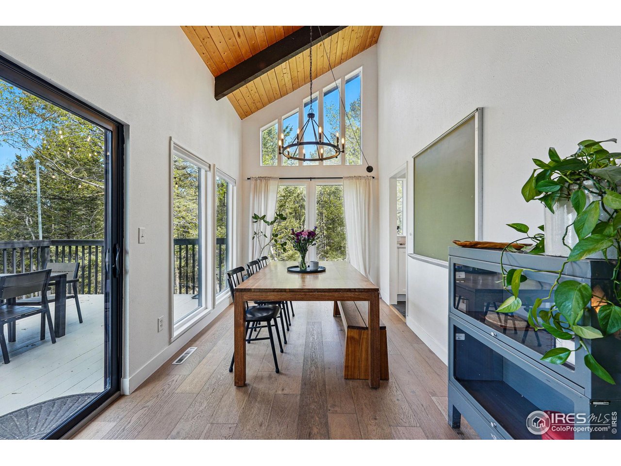 1750 Deer Trail Road Boulder, CO 80302 - Photo 15 of 50 a dining room with wooden floor a glass table and chairs