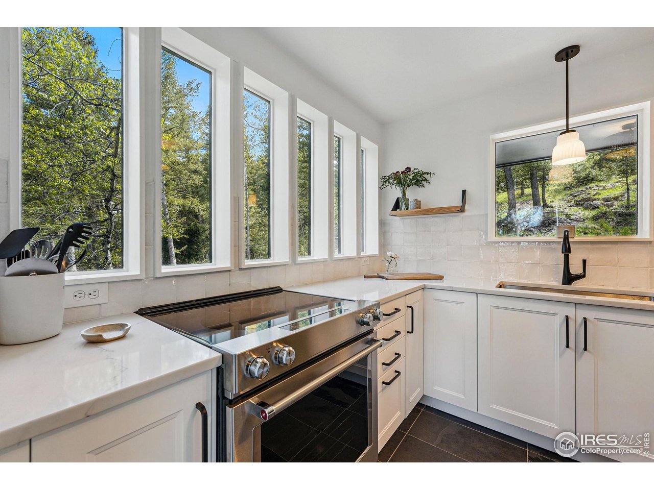 1750 Deer Trail Road Boulder, CO 80302 - Photo 21 of 50 a kitchen with a stove a sink a window and cabinets