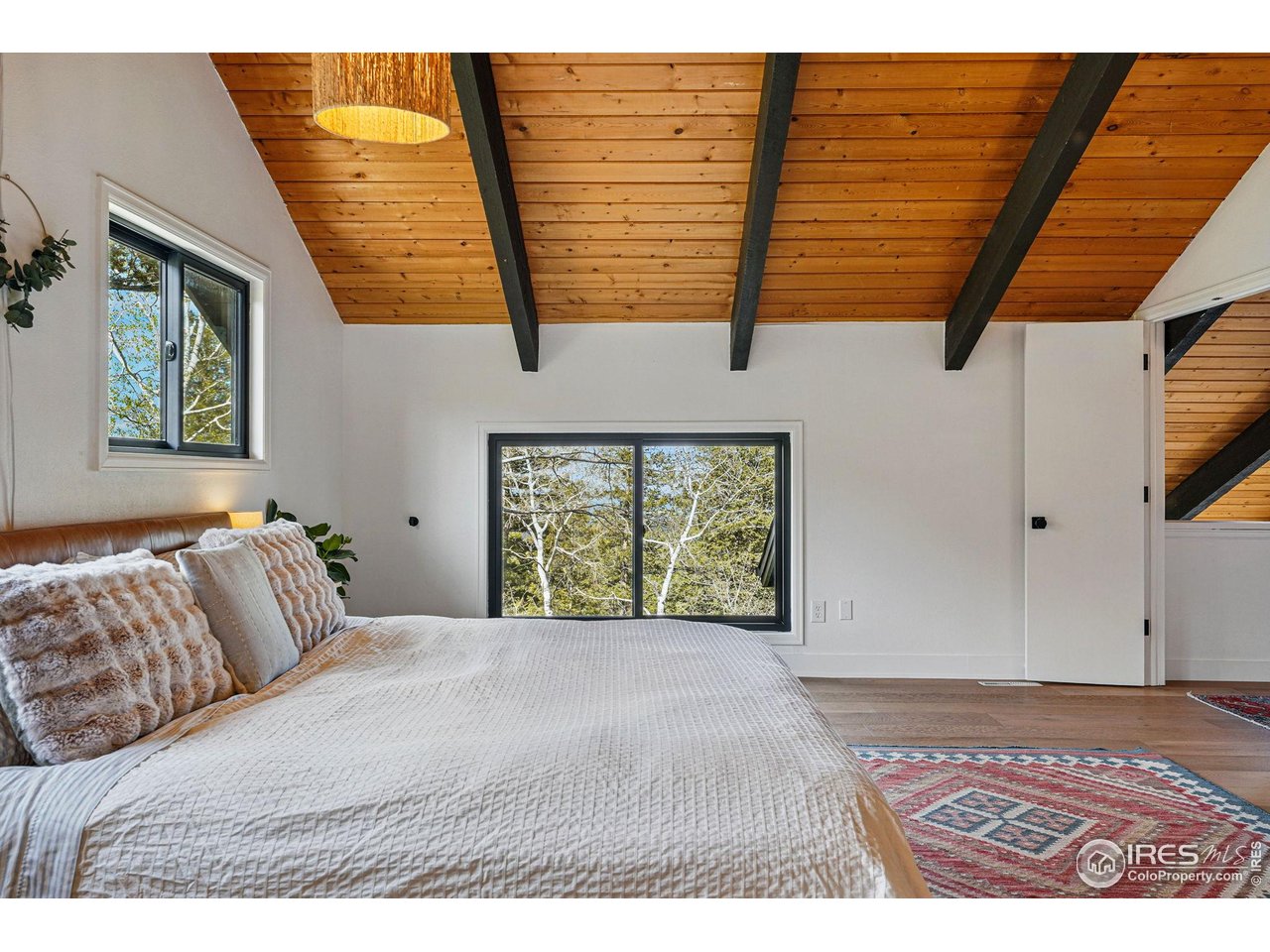 1750 Deer Trail Road Boulder, CO 80302 - Photo 39 of 50 a bedroom with a bed and a window