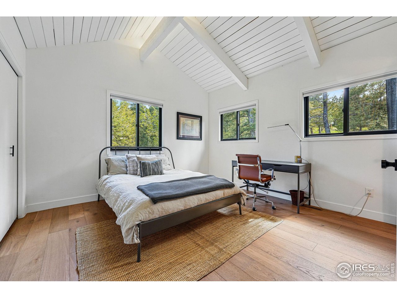 1750 Deer Trail Road Boulder, CO 80302 - Photo 42 of 50 a bedroom with a bed a table and painting on the wall