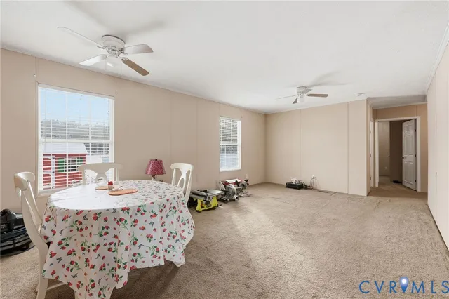 a kitchen with stainless steel appliances a sink a stove a refrigerator cabinets and a window