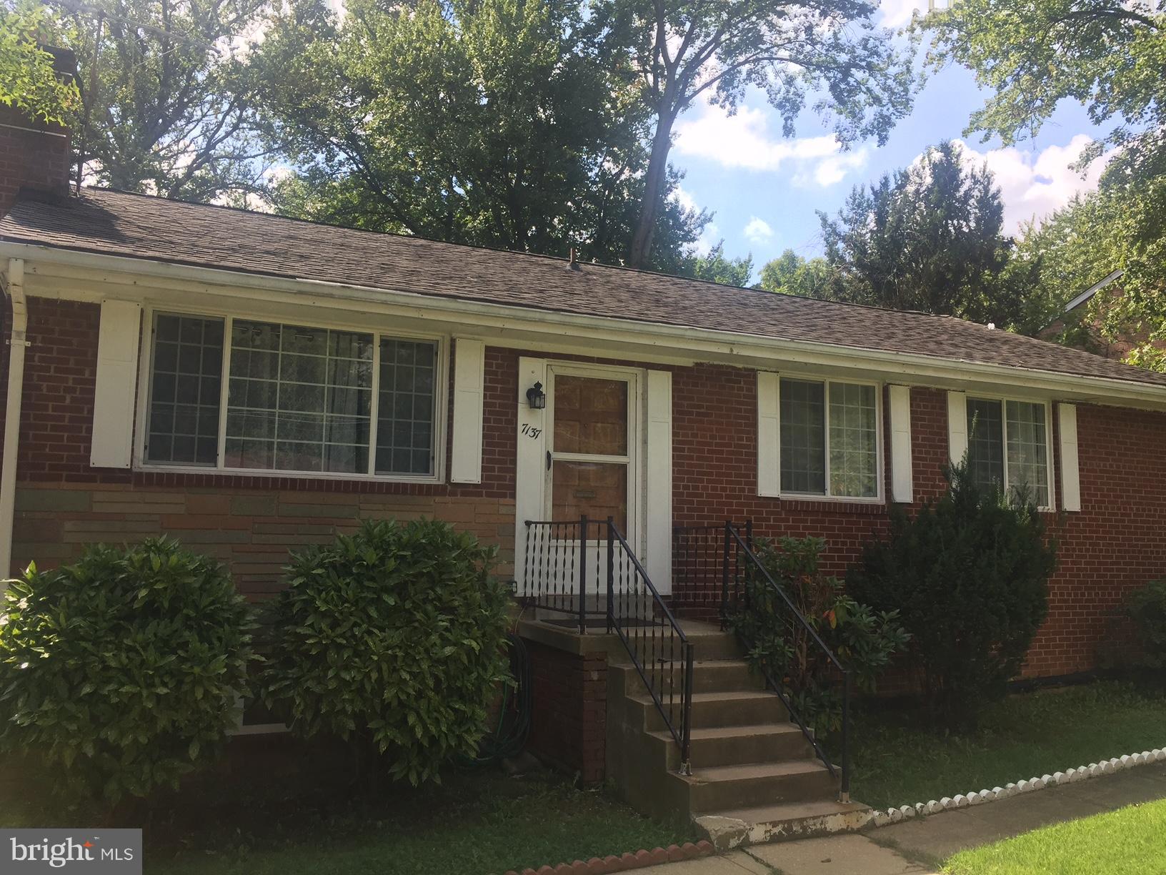 7137 Rice Street Falls Church, VA 22042 - Photo 1 of 17 a front view of a house with a garden