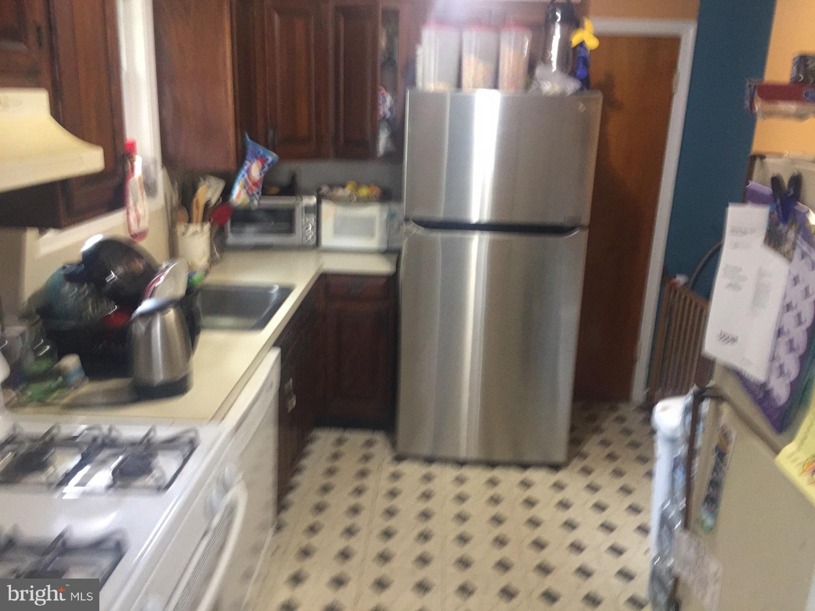 7137 Rice Street Falls Church, VA 22042 - Photo 4 of 17 a kitchen with a refrigerator and a sink
