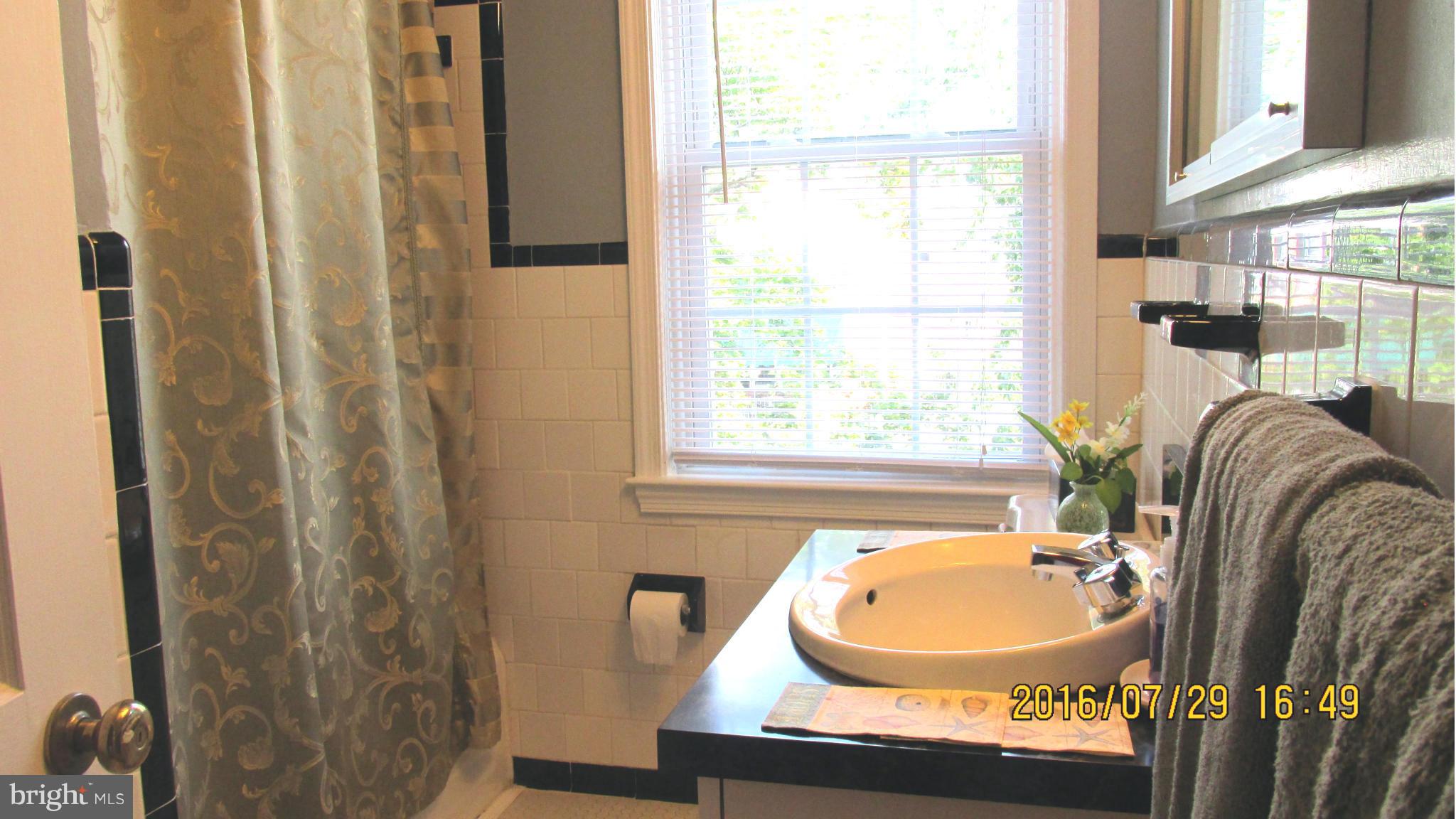 8134 Pleasant Plains Road Baltimore, MD 21286 - Photo 13 of 28 Classic B&W ceramic tiled bath.