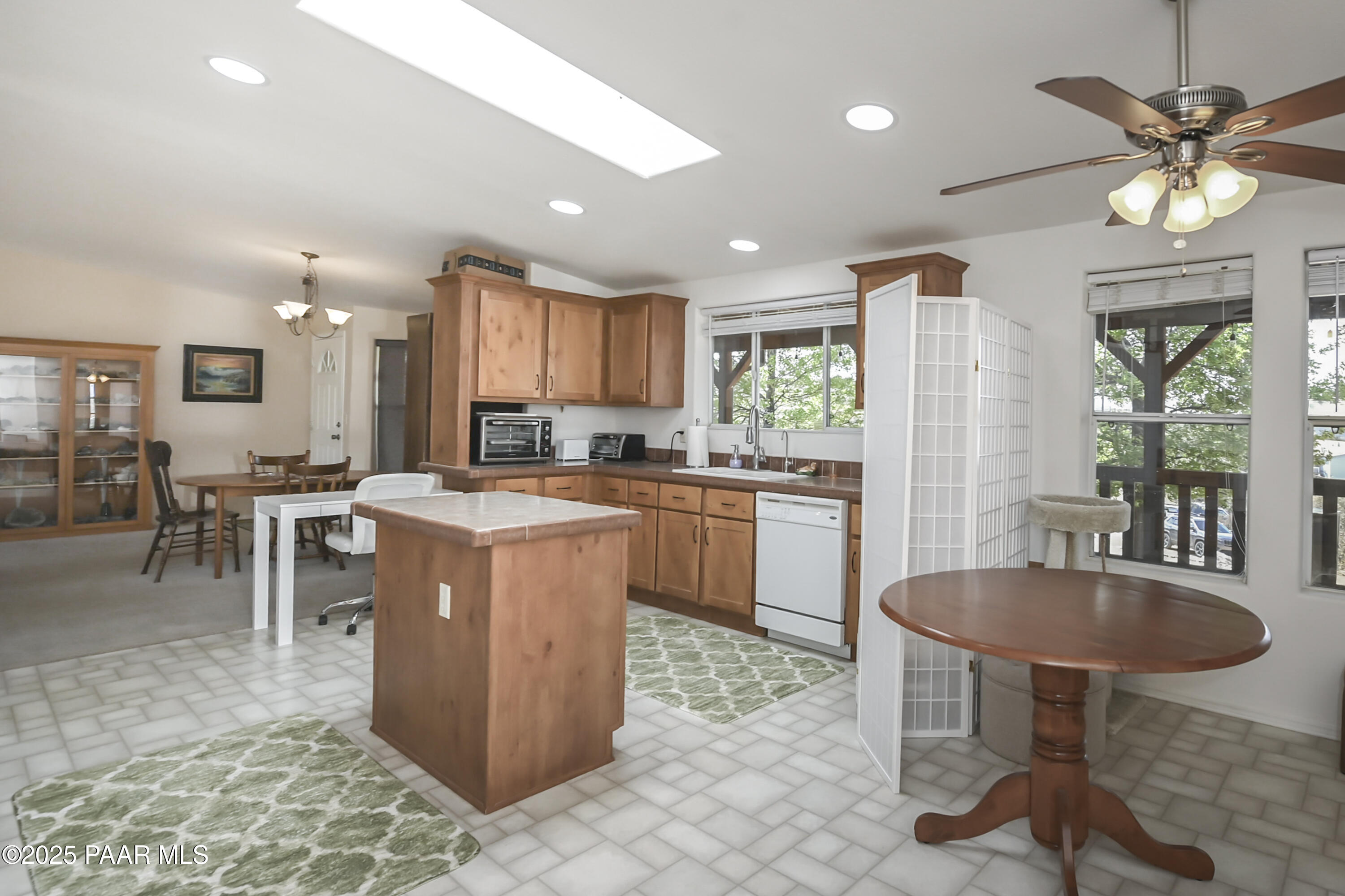 17985 East Hunters Lane Dewey, AZ 86327 - Photo 13 of 41 a kitchen with kitchen island granite countertop a sink counter and chairs