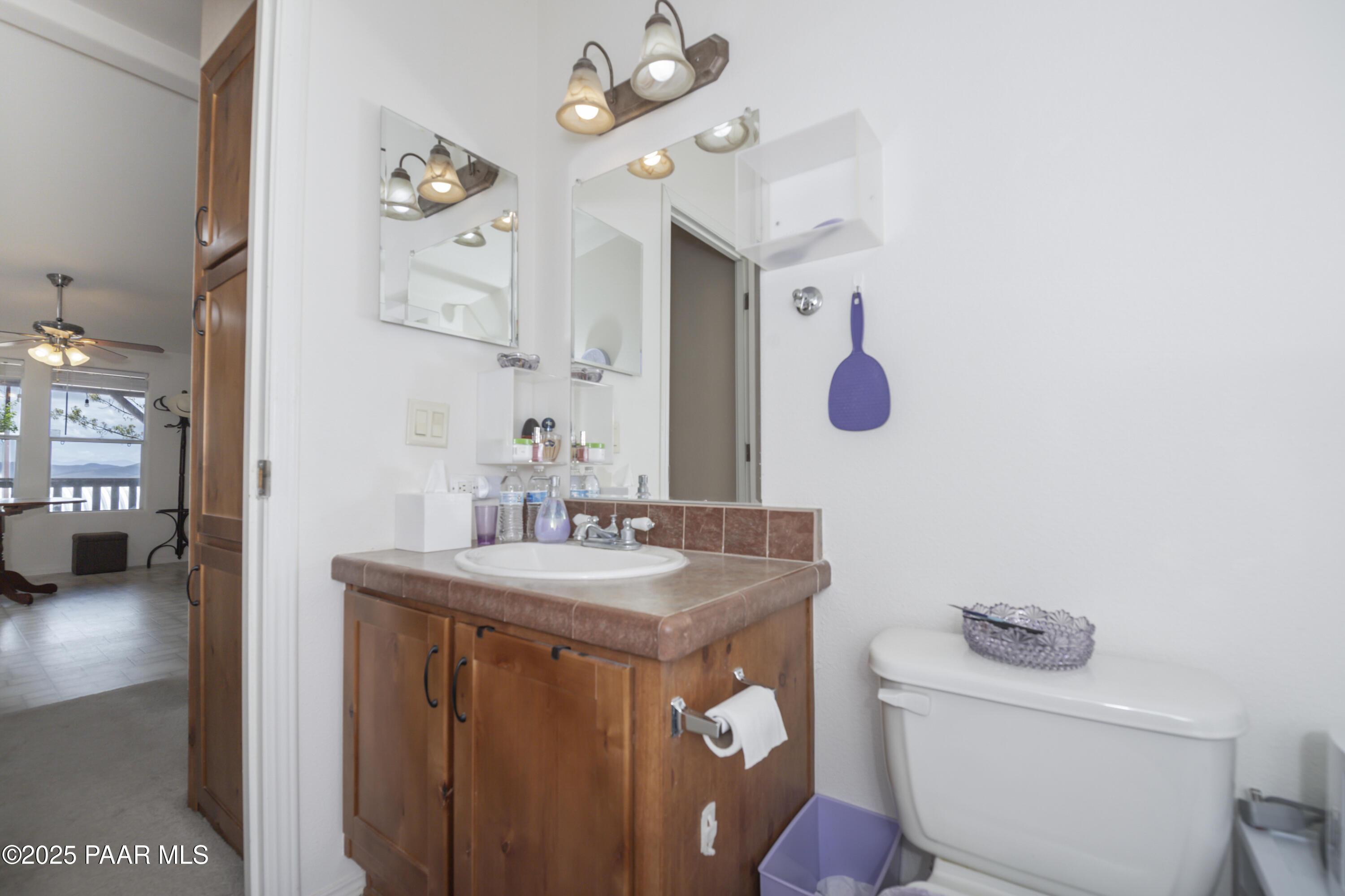 17985 East Hunters Lane Dewey, AZ 86327 - Photo 19 of 41 a bathroom with a sink a toilet and mirror