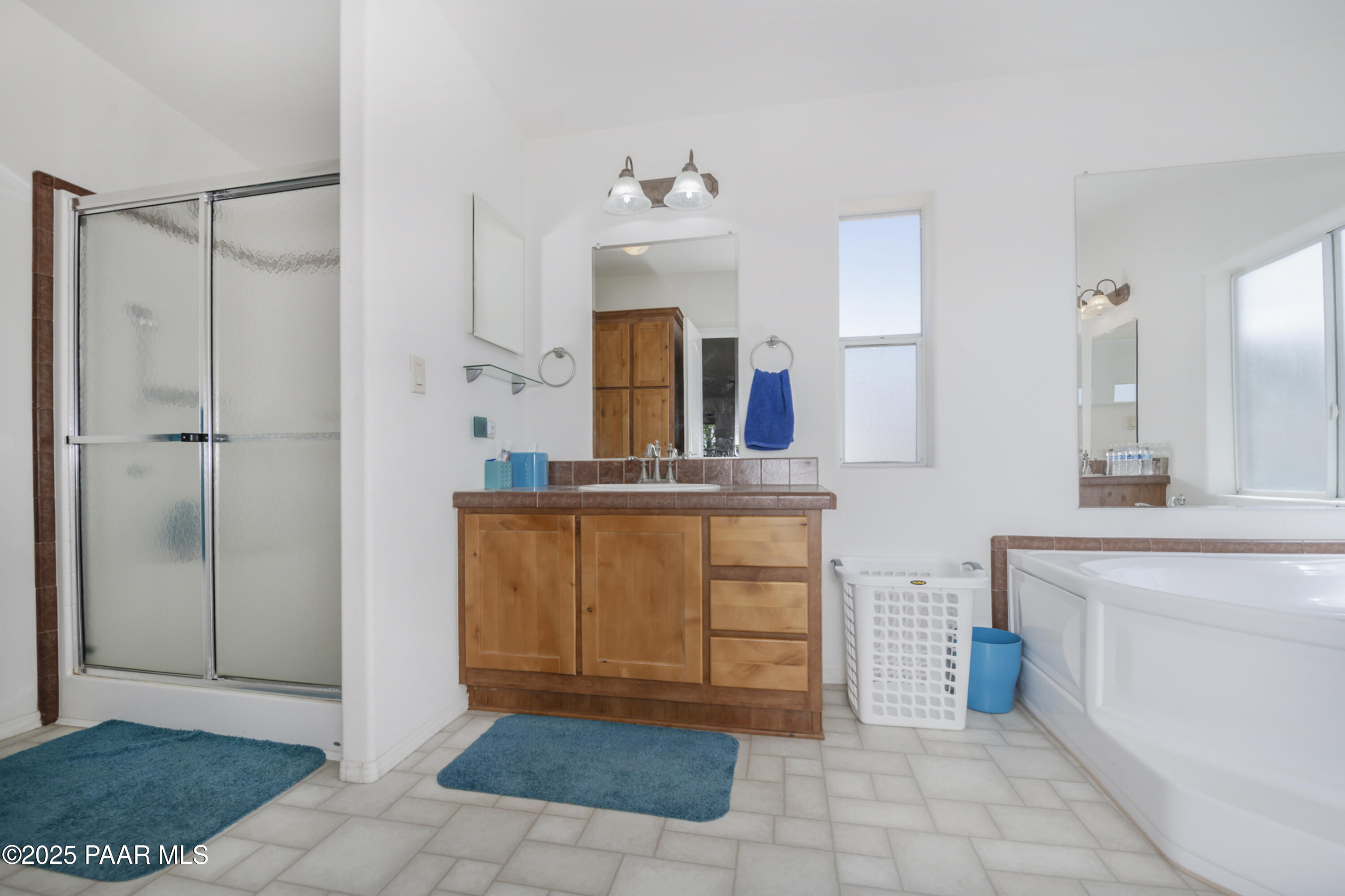 17985 East Hunters Lane Dewey, AZ 86327 - Photo 26 of 41 a bathroom with a sink a mirror and a shower