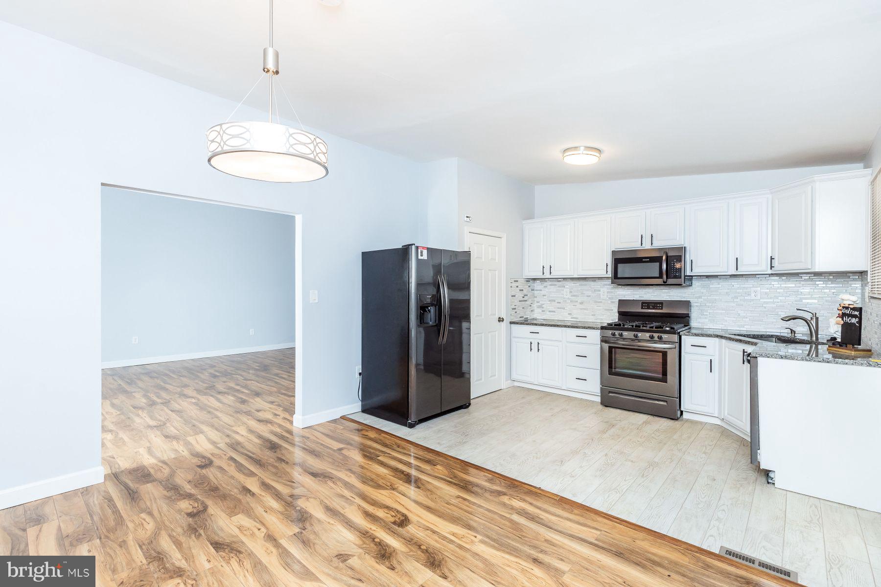 8122 Scotts Level Road Baltimore, MD 21208 - Photo 5 of 18 New tile floor in the kitchen