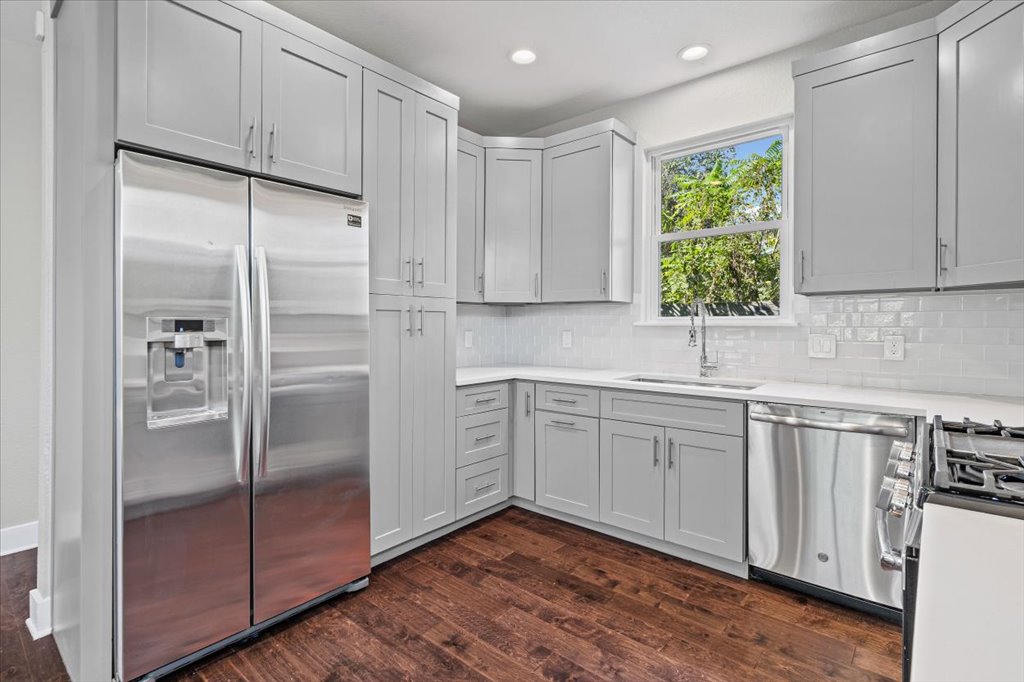 706 Short Kemp Street, Unit 2 Austin, TX 78741 - Photo 14 of 34 a kitchen with stainless steel appliances granite countertop a refrigerator and a sink