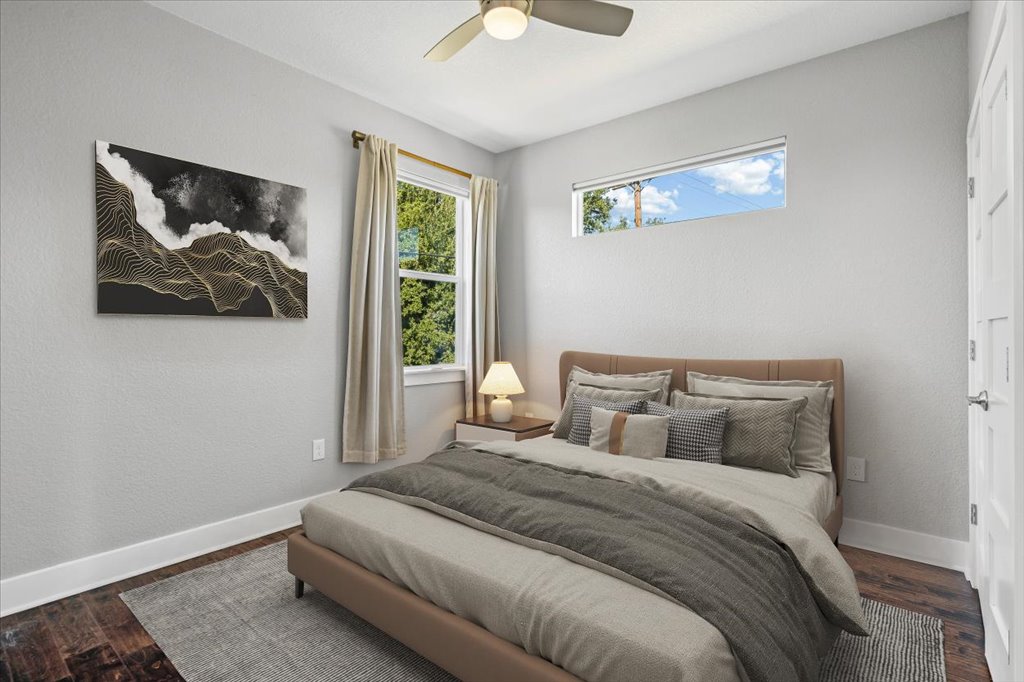 706 Short Kemp Street, Unit 2 Austin, TX 78741 - Photo 17 of 34 a bedroom with a bed and a painting on the wall