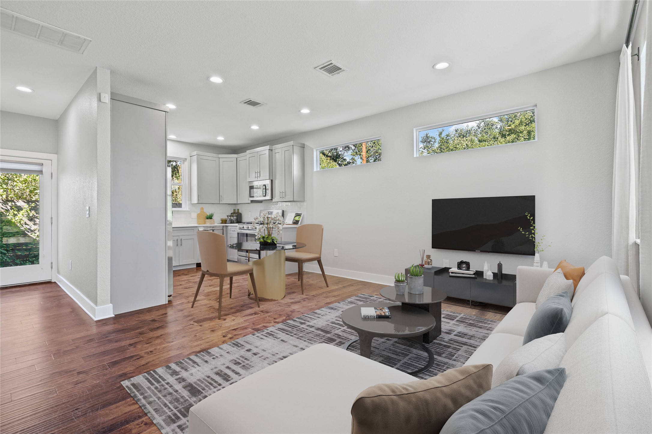 706 Short Kemp Street, Unit 2 Austin, TX 78741 - Photo 5 of 34 a living room with furniture and a flat screen tv