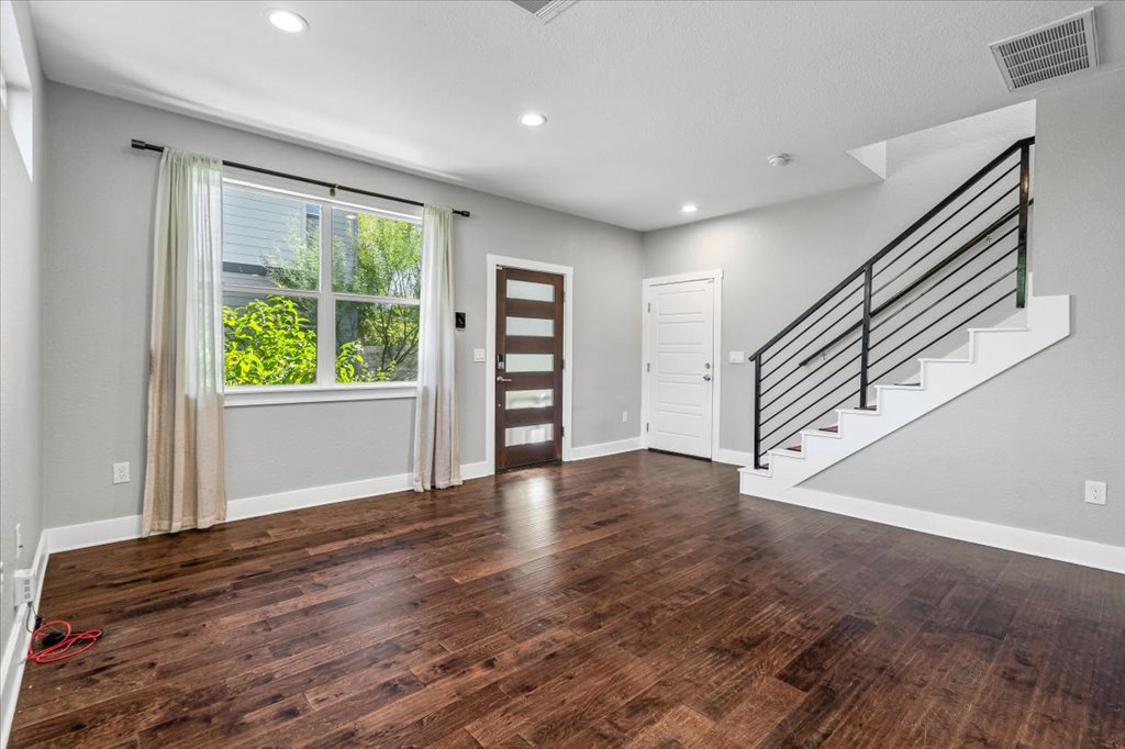 706 Short Kemp Street, Unit 2 Austin, TX 78741 - Photo 8 of 34 a view of an empty room with a window and wooden floor