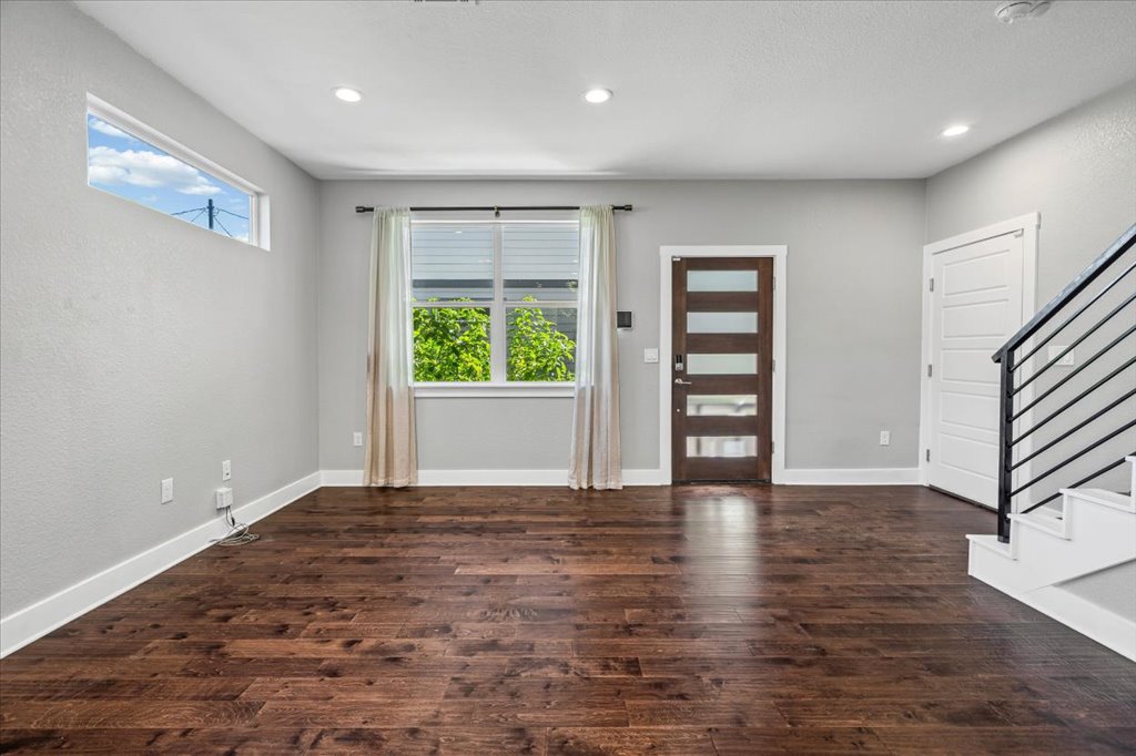706 Short Kemp Street, Unit 2 Austin, TX 78741 - Photo 9 of 34 a view of an empty room with a window and wooden floor