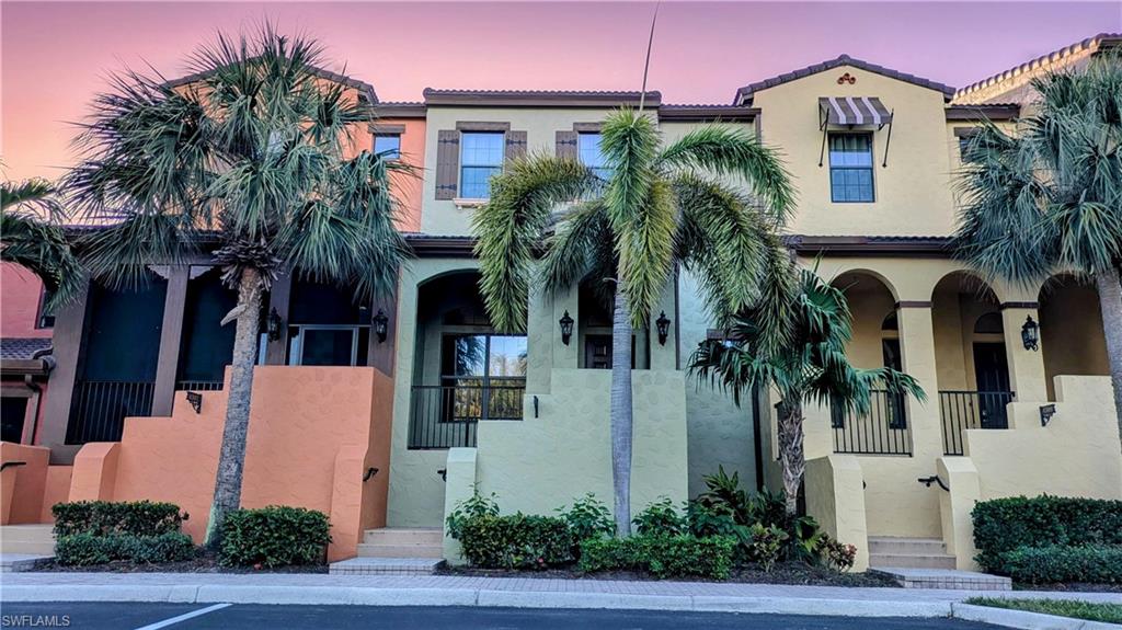 a front view of multiple houses with yard