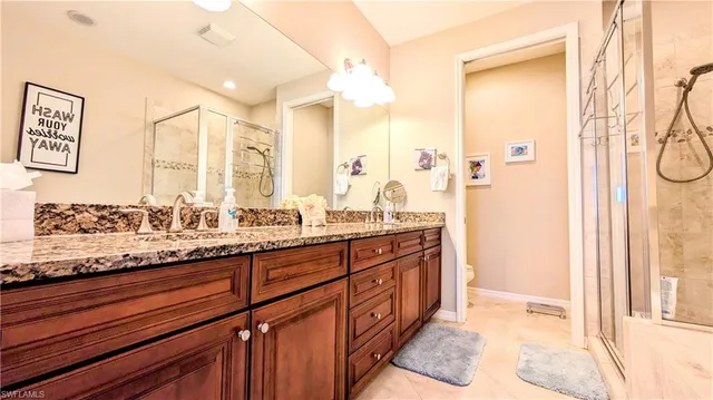 a spacious bathroom with a granite countertop sink and a mirror