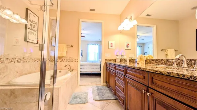 a large white kitchen with a large window and sink
