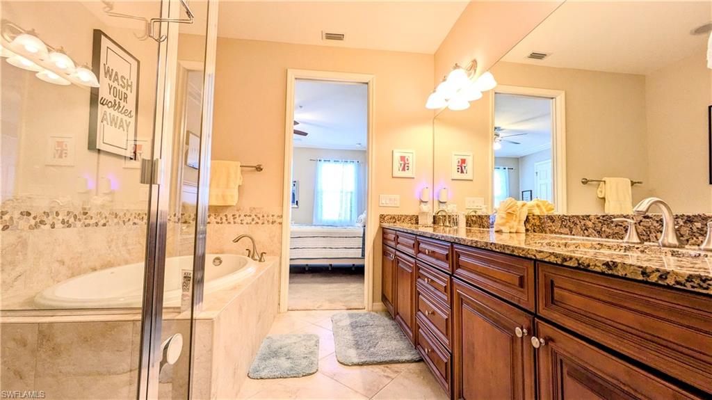 9051 Capistrano Street North, Unit 4308 Naples, FL 34113 - Photo 14 of 45 a large white kitchen with a large window and sink