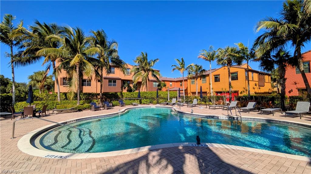 9051 Capistrano Street North, Unit 4308 Naples, FL 34113 - Photo 18 of 45 a view of swimming pool with outdoor seating