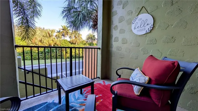 a view of a chairs and table in a balcony