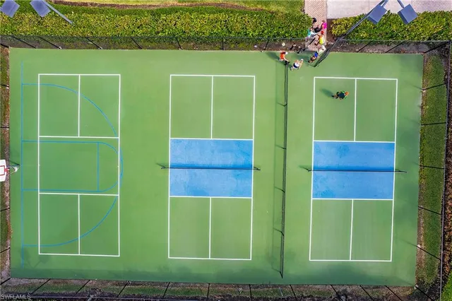 a green field with some trees in the background