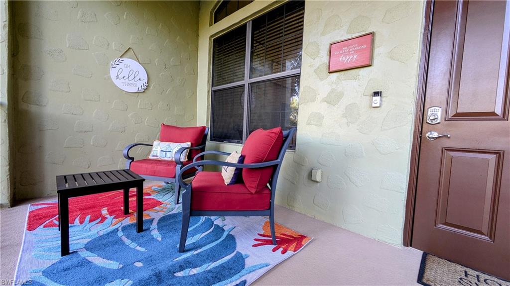 9051 Capistrano Street North, Unit 4308 Naples, FL 34113 - Photo 32 of 45 a living room with furniture and a wooden floor