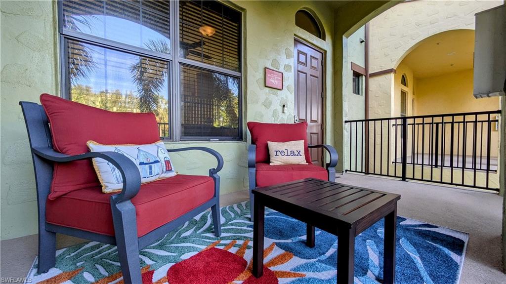 9051 Capistrano Street North, Unit 4308 Naples, FL 34113 - Photo 33 of 45 a couple of chairs sitting in front of a building