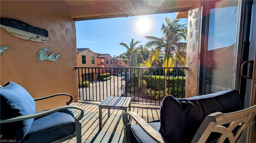 9051 Capistrano Street North, Unit 4308 Naples, FL 34113 - Photo 40 of 45 a view of a balcony with furniture