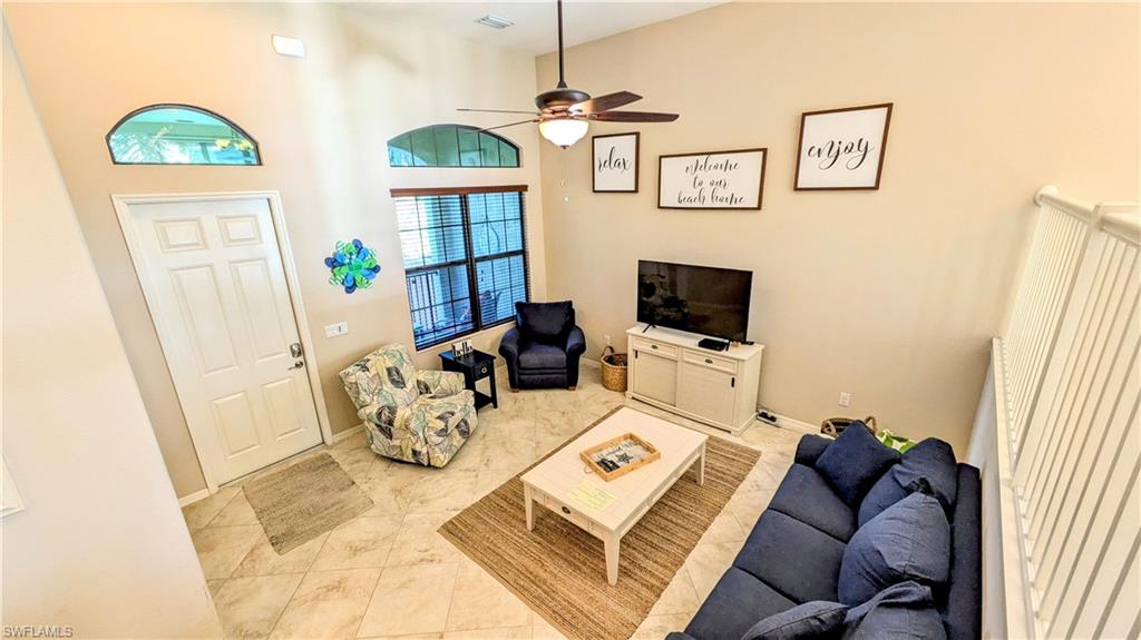 9051 Capistrano Street North, Unit 4308 Naples, FL 34113 - Photo 4 of 45 a living room with furniture and a window