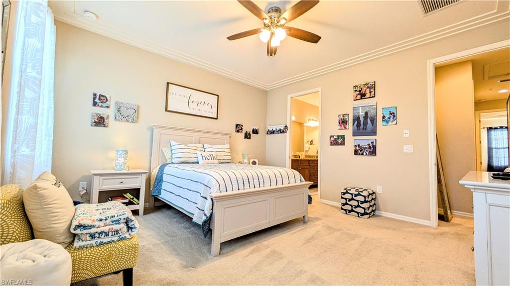 9051 Capistrano Street North, Unit 4308 Naples, FL 34113 - Photo 42 of 45 a spacious bedroom with a bed and a couch