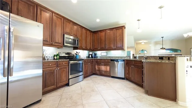 a kitchen with granite countertop stainless steel appliances and cabinets