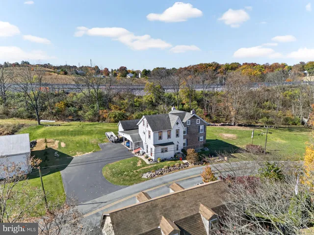 an aerial view of a house with a garden and lake view