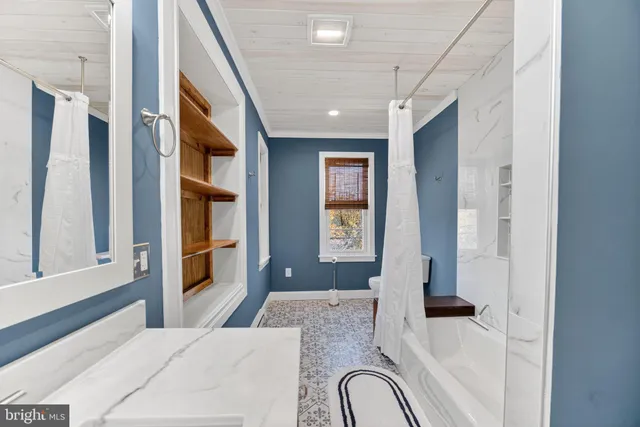 a bedroom with a bed dresser and a window