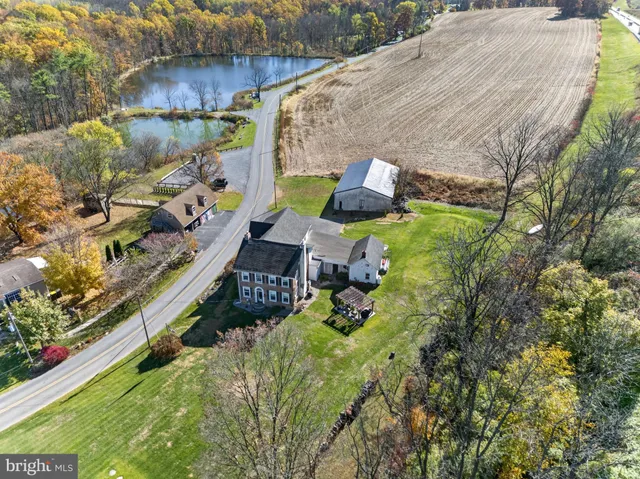 a view of a house with a big yard and potted plants