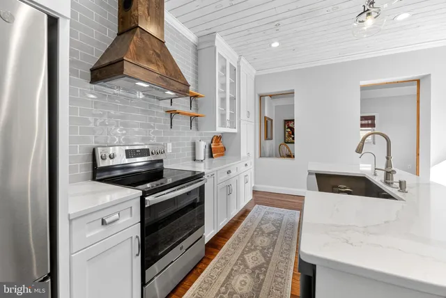 a kitchen with stainless steel appliances granite countertop a sink and stove top oven