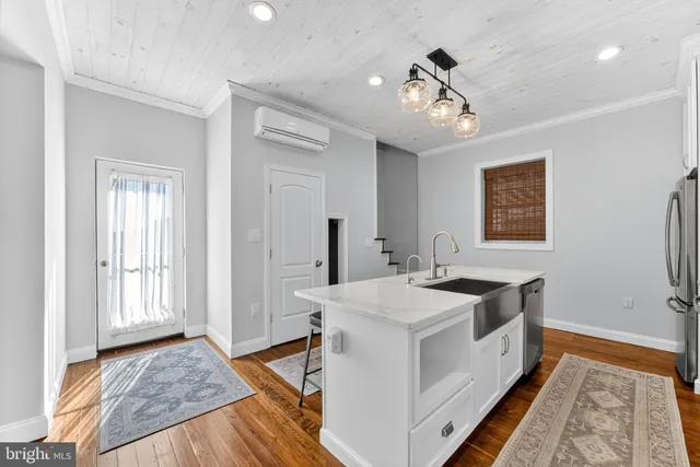a spacious bathroom with a granite countertop sink a mirror and vanity
