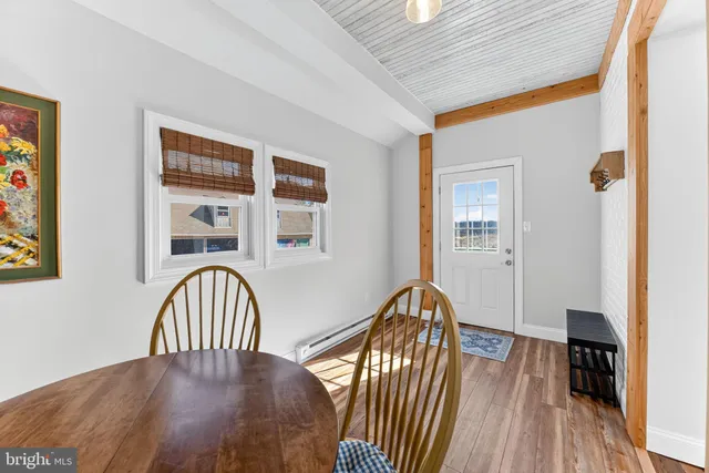 a view of a dining room with furniture and wooden floor