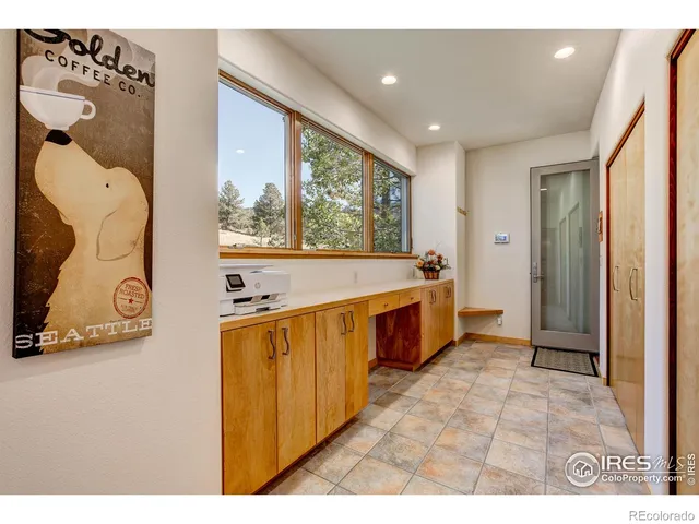 a large white kitchen with a large window