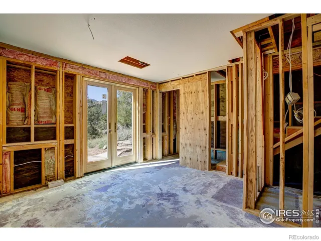 a view of an empty room with a fireplace and windows