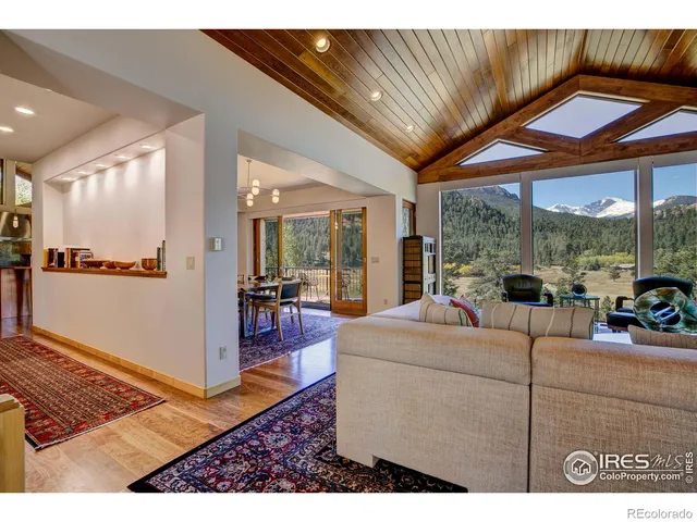 a living room with furniture and a floor to ceiling window