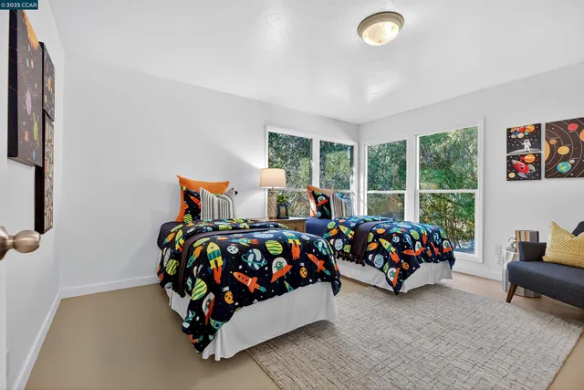 a bedroom with three beds and a large window