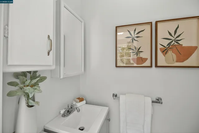 a bathroom with a sink and mirror with window