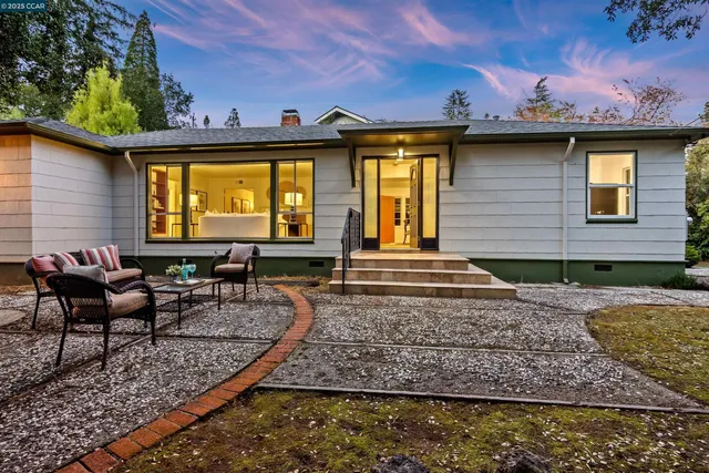 a backyard of a house with outdoor seating