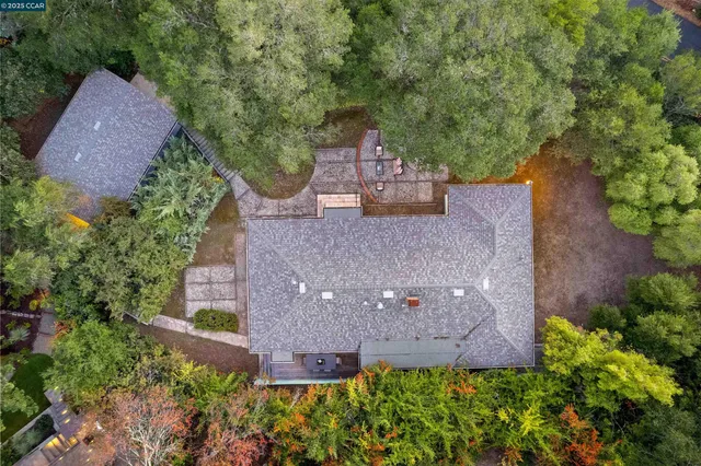 an aerial view of a house with a yard and garden