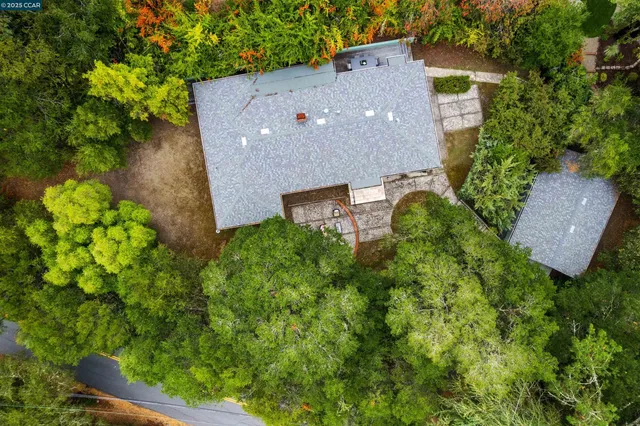 an aerial view of a house with a yard
