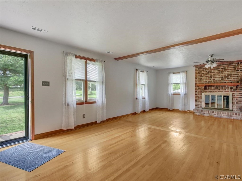 6881 Miller Road Richmond, VA 23231 - Photo 9 of 23 Large family room with fireplace and ceiling fan.