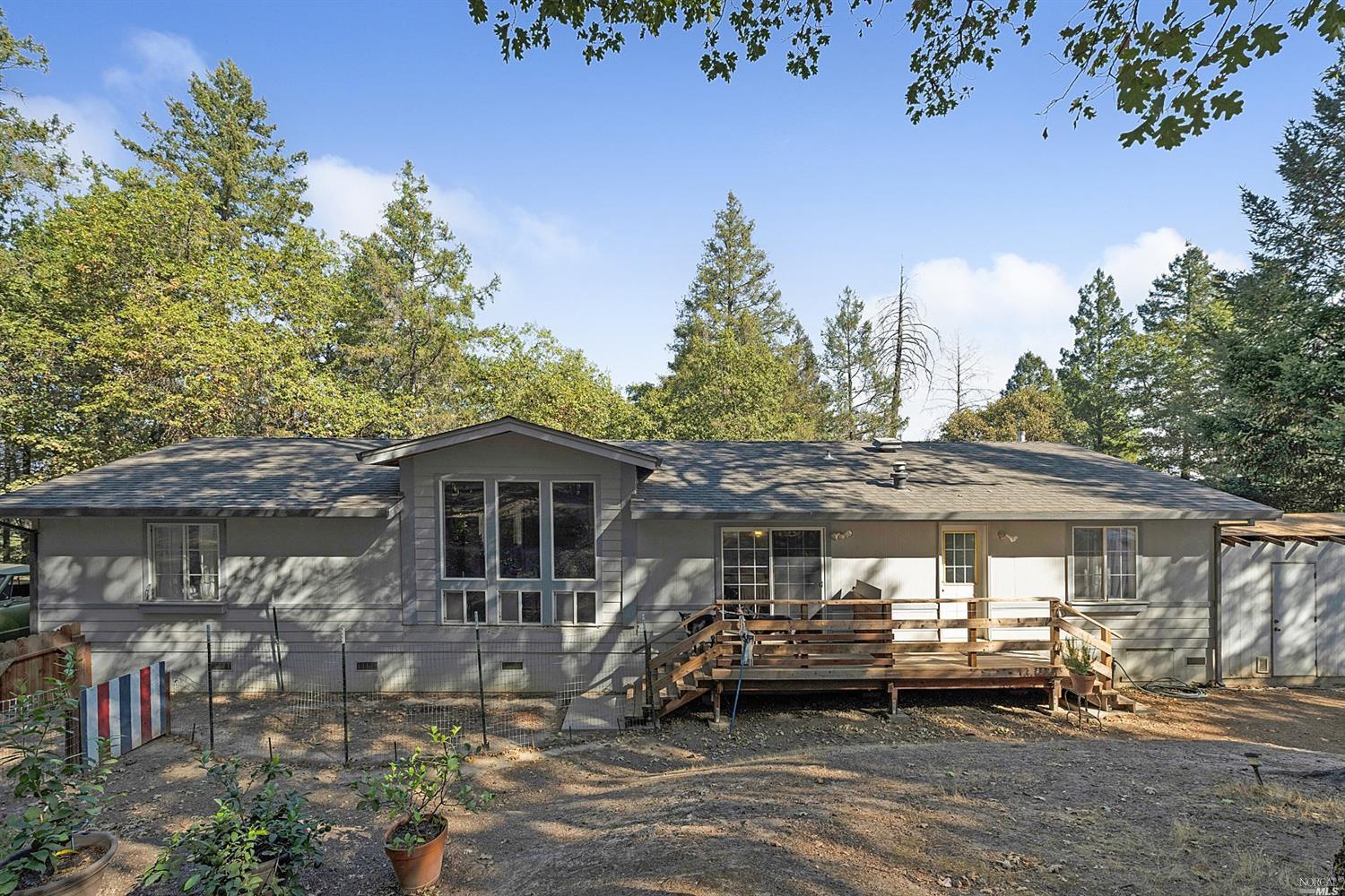 The home has tall windows in the rear that add lots of natural light and enjoyment of the outdoor beauty.