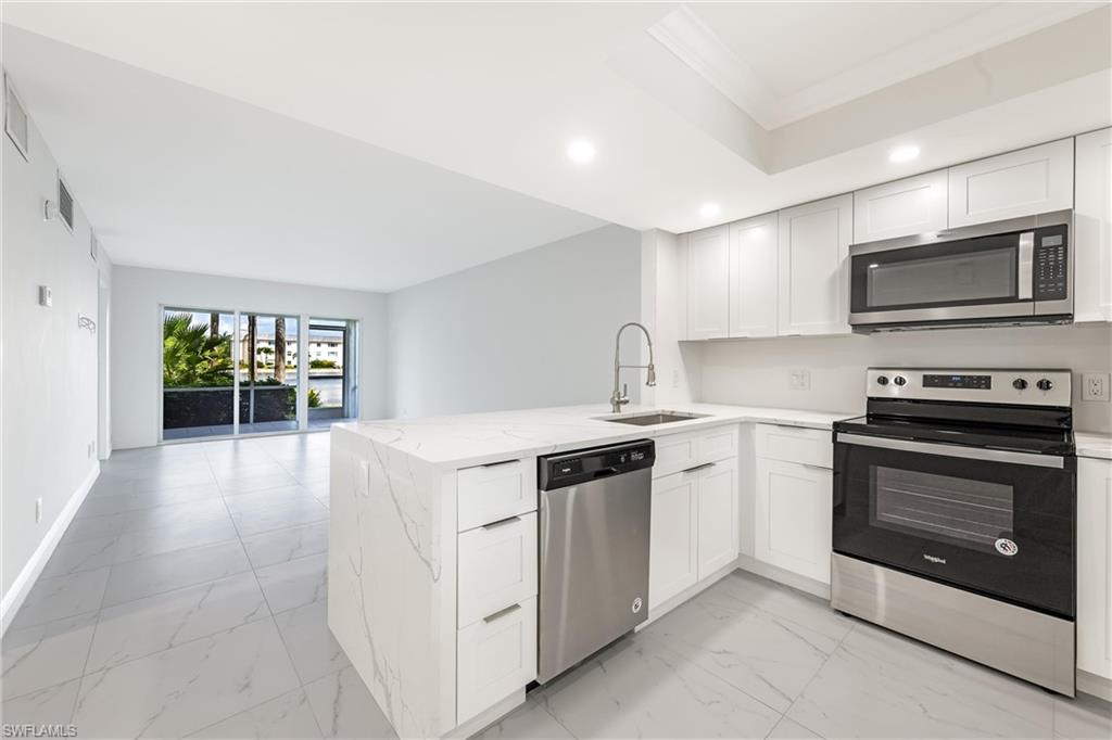 a kitchen with stainless steel appliances granite countertop a stove and a sink