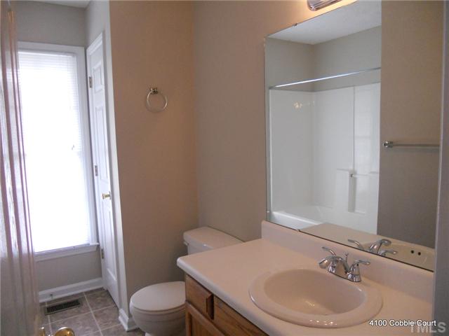 4100 Cobble Court Raleigh, NC 27616 - Photo 13 of 21 a bathroom with a sink a toilet and shower