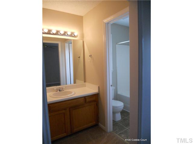 4100 Cobble Court Raleigh, NC 27616 - Photo 17 of 21 a bathroom with a sink and a mirror